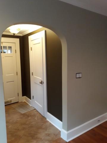 The daring accent color is darker than the neutral walls and it really helps this foyer are pop after new paint.