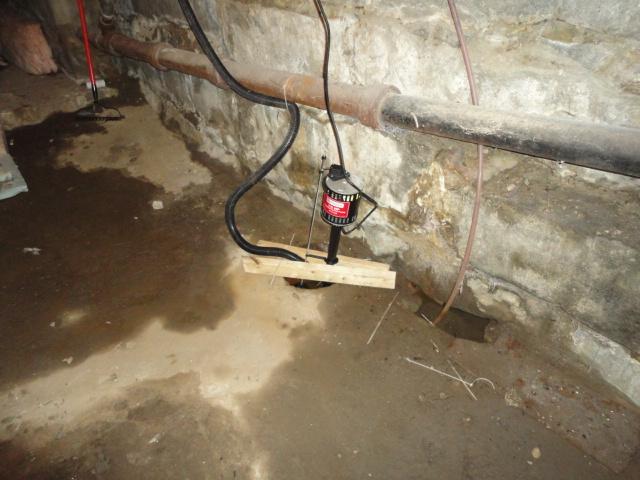 The basement of this Goshen, CT home had a water problem, seen in the wet areas on the dirt floor. We installed our WaterGuard sub-floor drainage system around the perimeter of the room. Our team can install our system even in non-ideal basements such as this, to keep the basement dry for the homeowners to enjoy.