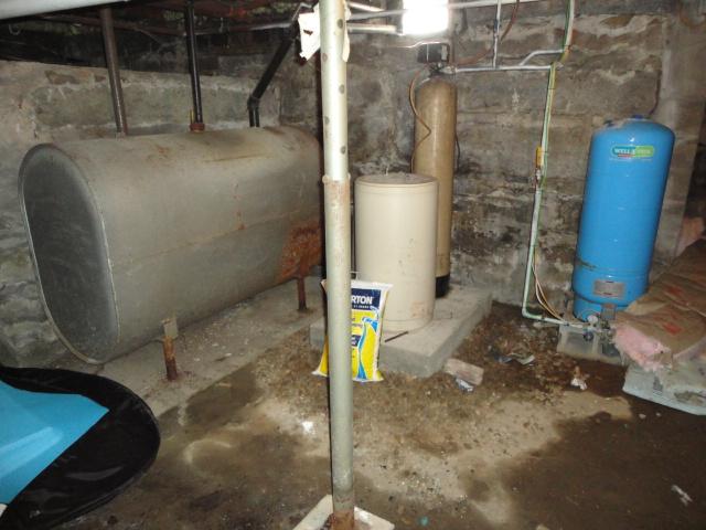 The basement of this Goshen, CT home was very wet; water had seeped in through the small cracks in the fieldstone foundation walls. To dry out the area, we installed our SuperSump pump system. This powerful sump pump can remove up to 2,500 gallons of water per hour, and it can even be installed in highly unfinished basements such as this one. The homeowners now have a dry basement to use and enjoy.