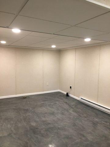 What a difference! The basement is much brighter and finished with water-resistant, mold-proof products that are attractive and low-maintenance.