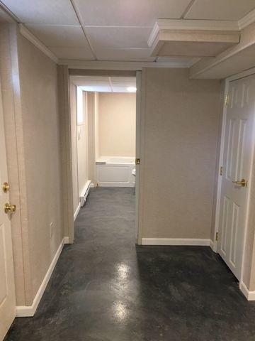 Straight ahead, a full bathroom was installed. Thanks to the water-resistant design of our Total Basement Finishing system, should a leak or flood occur in the bathroom or anywhere else in the basement, the walls, ceiling tiles, and other TBF products (such as crown molding) will not be ruined.