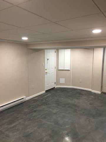 One last image of the finished basement shows a newly-installed interior door along with a few other TBF products that make the space complete.