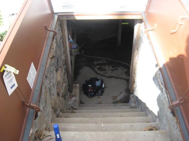 The hatchway stairs leading into this Deep River, CT basement were allowing water to enter the area. To prevent this from causing flooding in the future, we installed our  TrenchDrain™ Grated Drainage Pipe System at the base of the stairs. This open grated drain will collect any water into the perimeter drainage system, preventing it from entering the basement. 