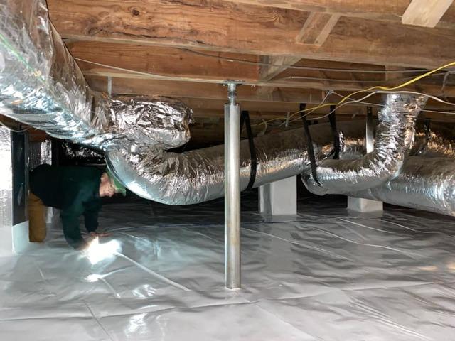 The crawl space after cleaning out the used plastic and installing CleanSpace. Also, the SmartJack placed to support the floor above it.