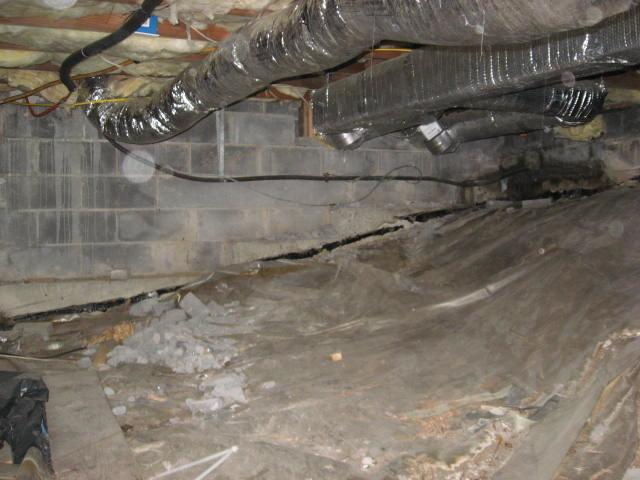 We often find crawl spaces with the floor covered in a plastic sheet, like the one in this Irvington, NY home. These attempts to seal off a crawl space are inadequate, as water can still leak in along the sides and through the walls, leaving it as an unviable area, even for storage. Wet crawl spaces have a high risk for mold, mildew, rot, and even pests! Our team installed our CleanSpace Crawl Space Encapsulation system throughout the area to fully seal it off. The durable plastic vapor barrier keeps out all moisture and odors, leaving the homeowners with a dry crawl space storage area. 