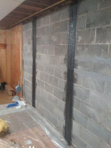 Other side of basement with leaning walls being straightened