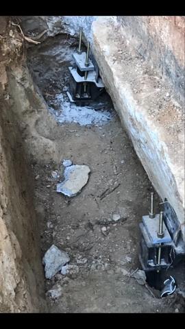 This shows an excavated foundation where piers are being added.