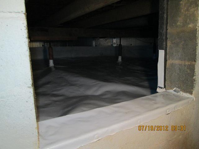 A view inside the crawlspace from the basement