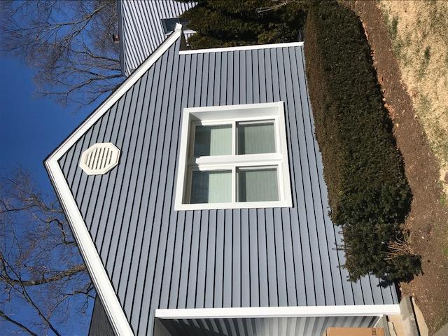 Flagstone Gray Siding with classic white window frames and trim with an octagonal vent