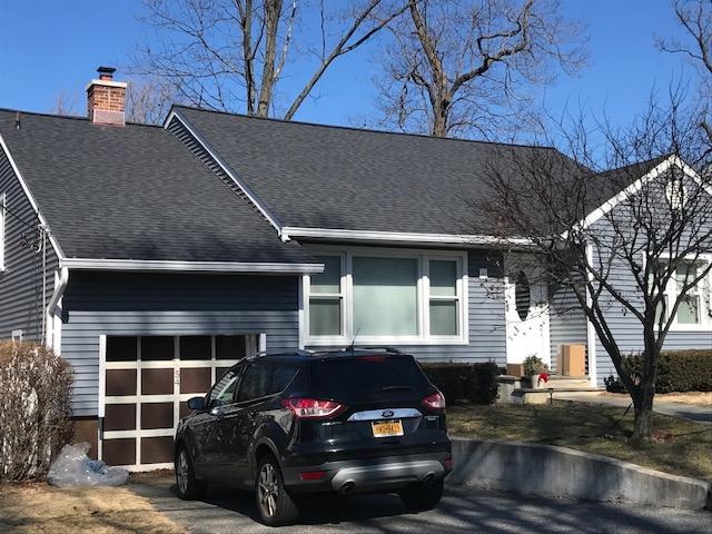 Flagstone gray CertainTeed Monogram Siding in Flagstone Gray with CertainTeed Landmark Roofing in Moire black.  Front Door is Therma Tru.