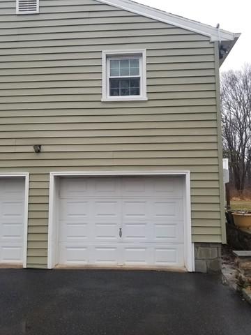 These garage doors are visibly brighter after pressure washing.