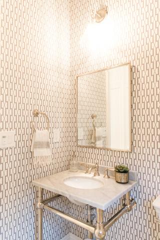 The highest of quality fixtures bring out the beauty in this powder room.