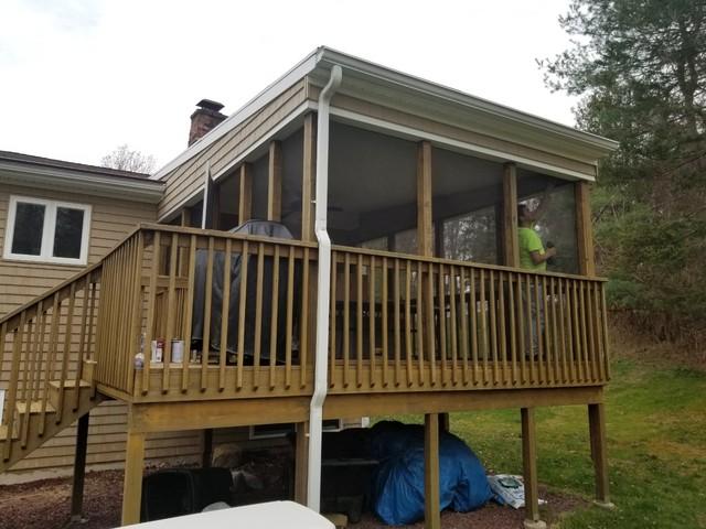 Painters remove the screens to prep for deck staining.