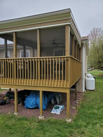 The porch railings and beams are perfectly stained.