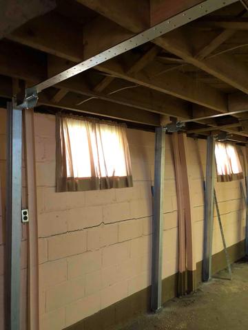 This system permanently stabilizes foundation walls with their custom-fit steel beams. They are tightly secured against the wall with brackets that are anchored to the basement floor and the framing above. This design can also be tightened over time, eliminating any further inward movement.