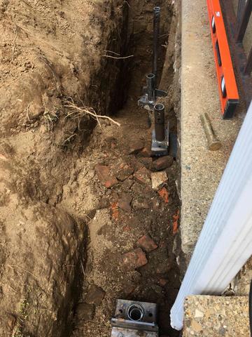 Helical Piers being installed to stabilize and repair foundation