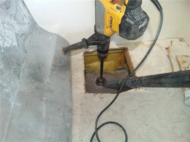 A hole in drilled into the home concrete slab to create a suction pit.