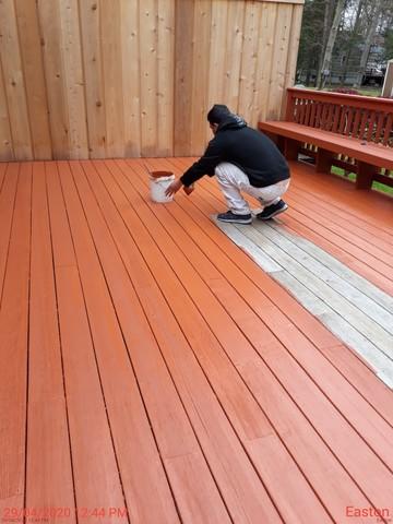 Painters are finishing up the first coat of stain for the deck floor and spindles.