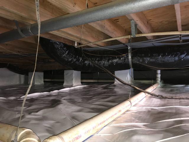 In addition to running CleanSpace vapor barrier along the block walls it is also best to wrap it up interior supports. Water and water vapor will find any way possible into crawl spaces, so the best way to drive the humidity down inside this crawl space was to wrap everything that has contact with the ground or the outside air in our vapor barrier.