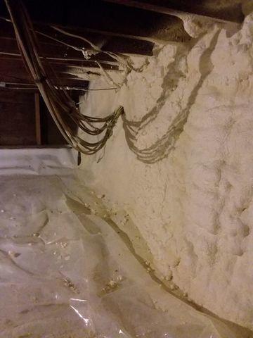 Closed cell spray foam is applied 3" inches thick and is airtight along the joists in this crawl space.