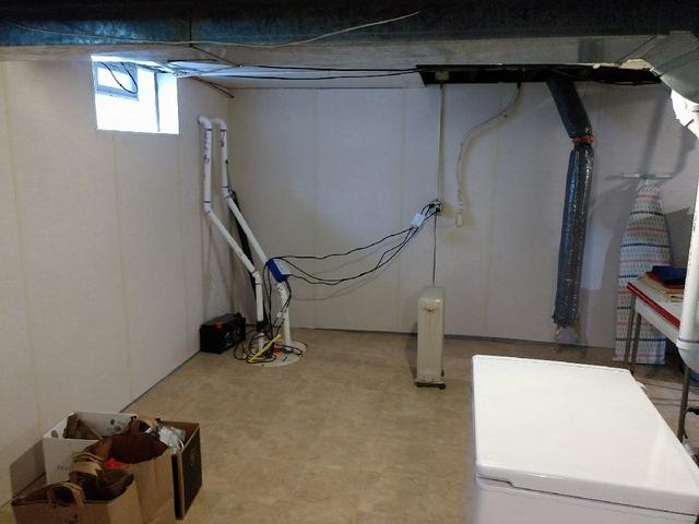 This basement now has a waterproofing system and fresh new ZenWall™ panels! This combination creates more useable storage and living space.