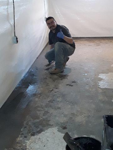 This is a photo of our foreman Juan installing WaterGuard against the floor/wall joint.