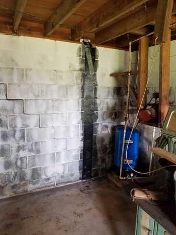 To start supporting the wall from potential collapse we installed strips along the entire wall.