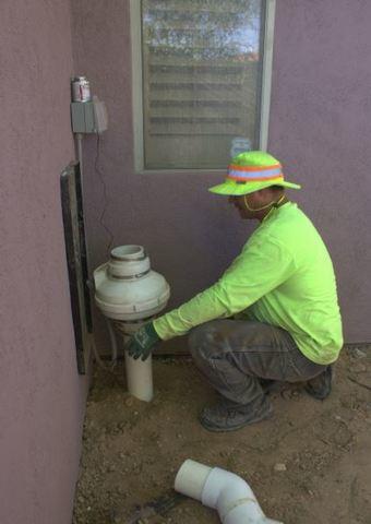 Arizona Foundation Solutions Foreperson, Danny Balderas, making sure the unit was level before adding the moisture outtake pipe.