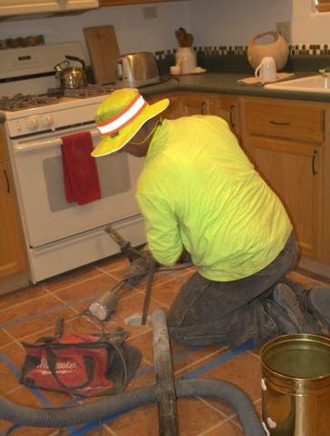 Arizona Foundation Solutions Foreperson, Danny Balderas, preparing to install the moisture sensor for the MoistureLevel Smart Foundation System beneath the foundation heave.