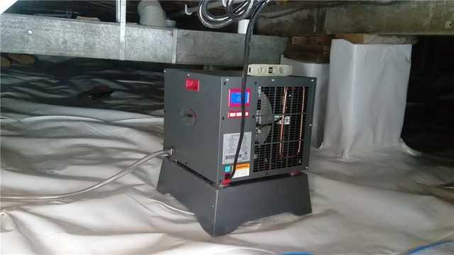 This image shows a SaniDry XP Basement Dehumidifier. These dehumidifiers are ten times more powerful than other dehumidifiers in order to get all unwanted water vapor out of the air.