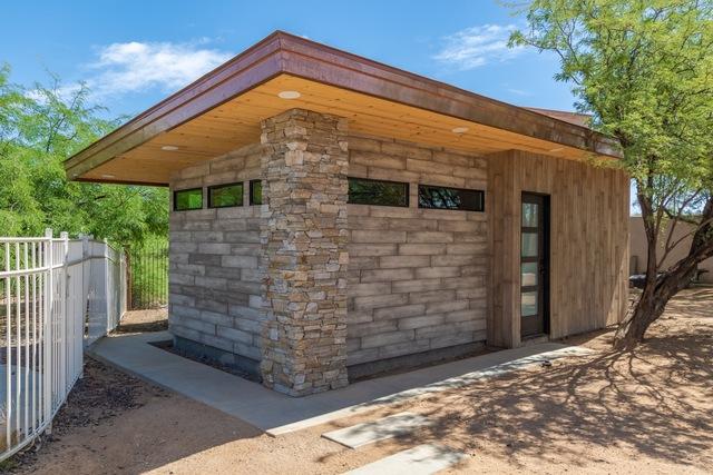 Look at the textures and lines. The post is made of natural quartzite stone. The wood look facade is cultured stone. Notice the copper facia with pine tongue and groove soffit. The tree was there before, so the facia was angled along the side to keep the tree as an added touch.