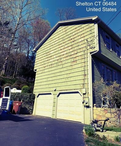 Painters sanded off the peeling paint on the side of the home.