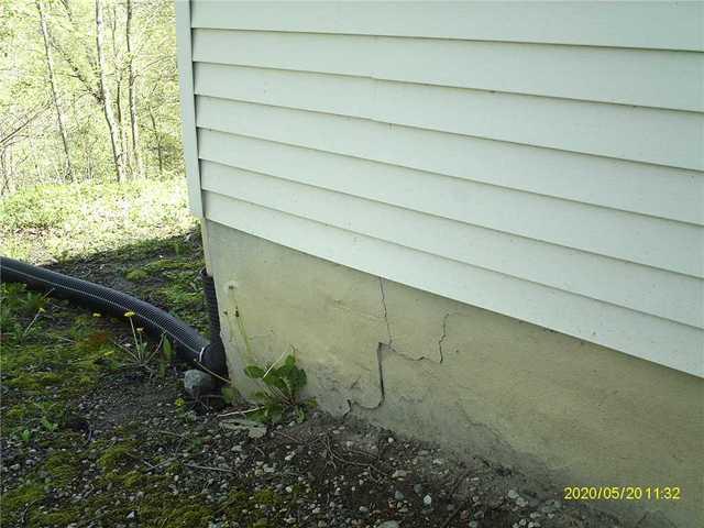 It's rare that the impact  of a weakened foundation wall is not seen outside. Here you can see a step stair crack which formed in this basement block wall.