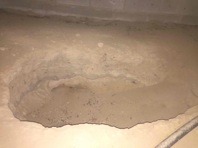 We often find large holes in crawl spaces. These are sometimes a result of old tree trunks being chopped down to build, old tree roots that have decayed, or just a result of construction. Either way, they are a low spot for water to collect and sit under the home, slowly evaporating and rising into he joists, insulation, and home.