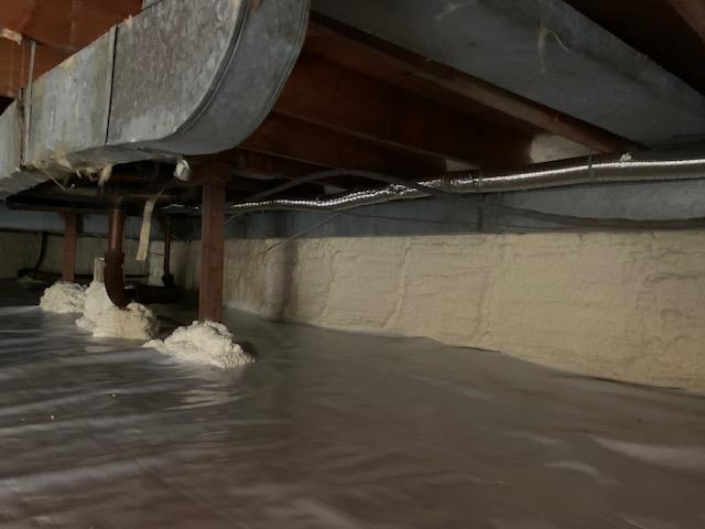 Bright new crawl space with beautifully installed spray foam insulation.