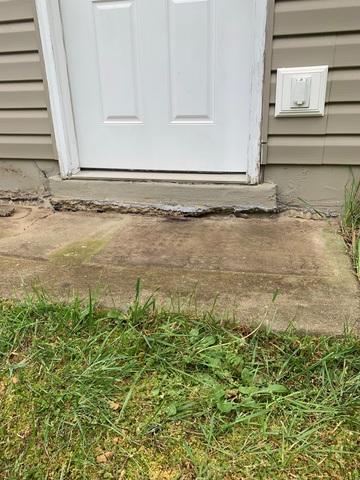 The sidewalk was sinking and separating from the house.