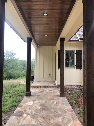 <p>Rough cut cedar post and shutters. Smooth cut tongue and groove ceiling with can lighting.</p>