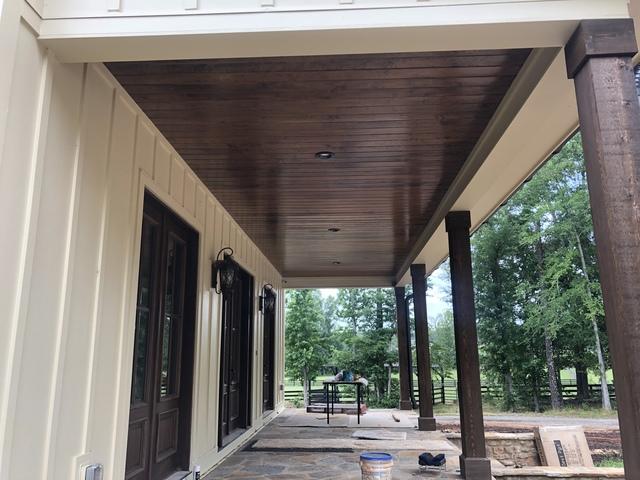 <p>Rough cut cedar post and shutters. Smooth cut tongue and groove ceiling with can lighting.</p>