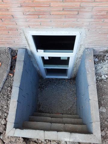 The finished window install. This is one of the more basic designs of egress windows that we can install.