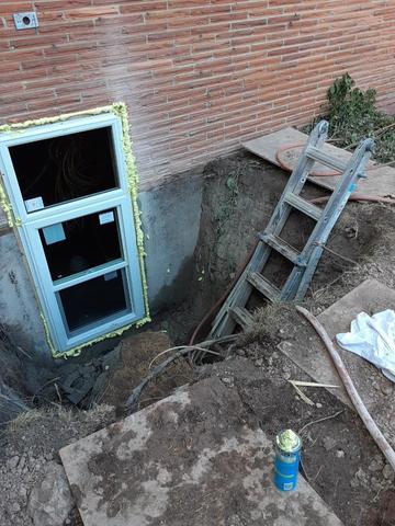 The egress window is installed and setting in it's fixture.