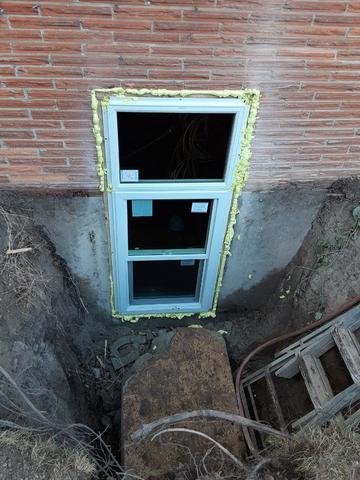 The egress window is installed and setting in its fixture.