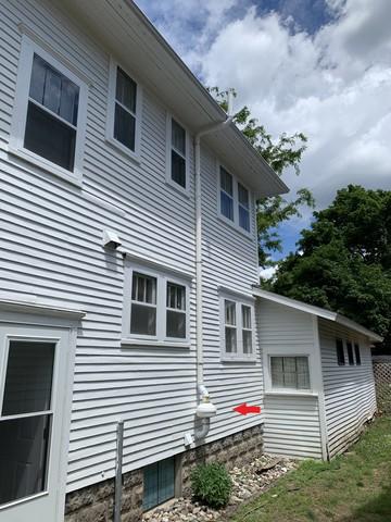 Exterior low voltage radon fan with schedule 40 vent pipe ran above the roof line.