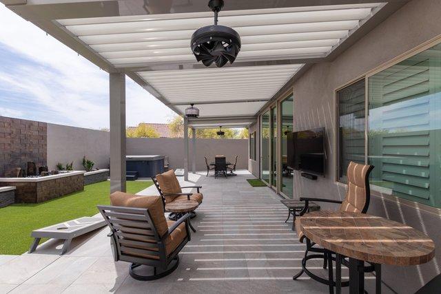 Here is a great daytime shot of the patio and back yard. As you can see, it's not a real large yard, but it is one that is very attractive and has more than enough to be able to entertain a large crowd or be a space of relaxation for the one at home.