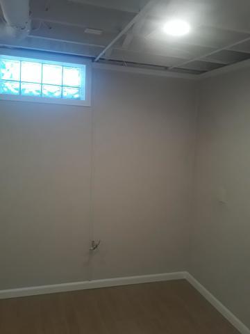 <p>Refinished walls and floors, ready for the washer and dryer to go back into the space.</p>