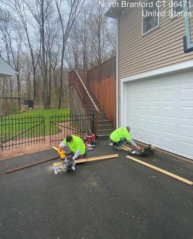 Carpenters cutting precise boards to replace damaged deck areas.