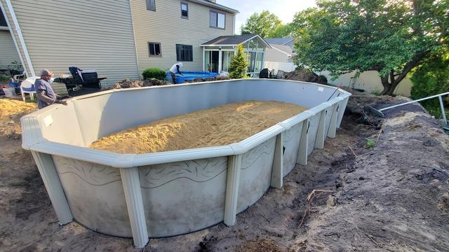 Once the walls are up, the sand is leveled to prepare for liner installation