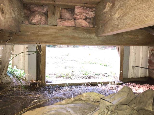 The entrance to this crawl space was covered using only a wooden board. The board does not stop moisture and air from leaking in. Over time, this cover will become warped and damaged by the ever-changing weather and storms. Outside influence entering the crawl space will raise the relative humidity. The high moisture content may cause wood rot, mold and mildew growth, structural damage, and puddles. This damp and dark environment is also perfect for creepy critters and creatures to set up home.