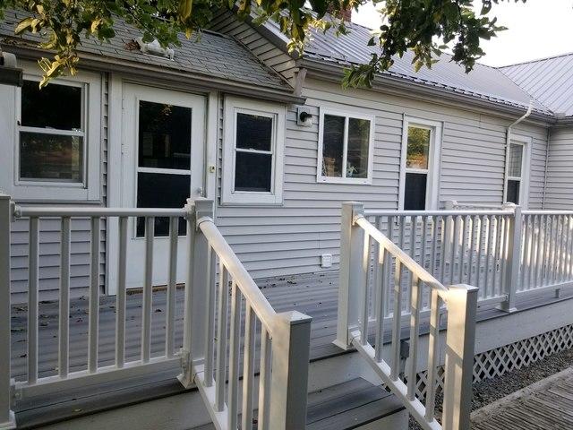 Front of the home with stairs leading to the front door