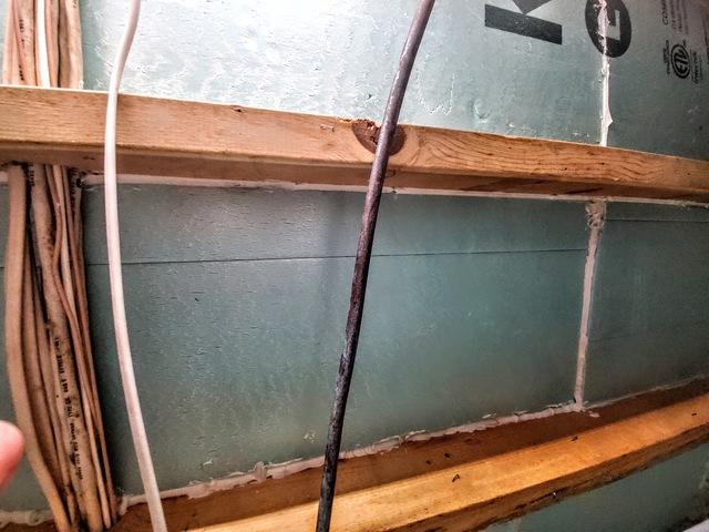 One section of the many meticulously cut and installed pieces of insulation that was installed throughout the floor joists.
