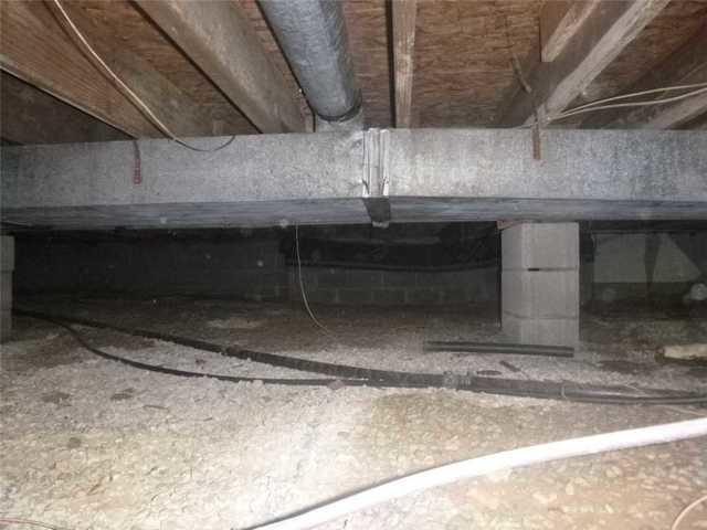 This is a typical crawlspace in need of a moisture barrier and dehumidification